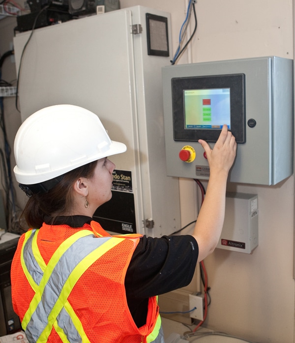 CarbonCure Installation Manager Diane Praught demonstrates the CarbonCure computer interface, which controls the injection of carbon dioxide gas into concrete mix.