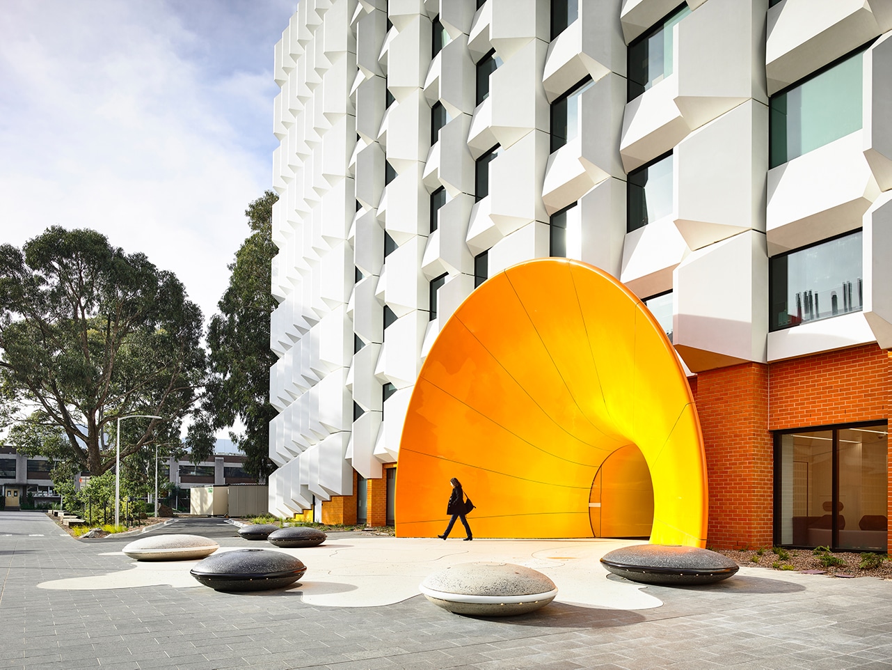 A New, Energy-Efficient Facade—and Dramatic Funnel Entryway—Transformed This University Building in Australia