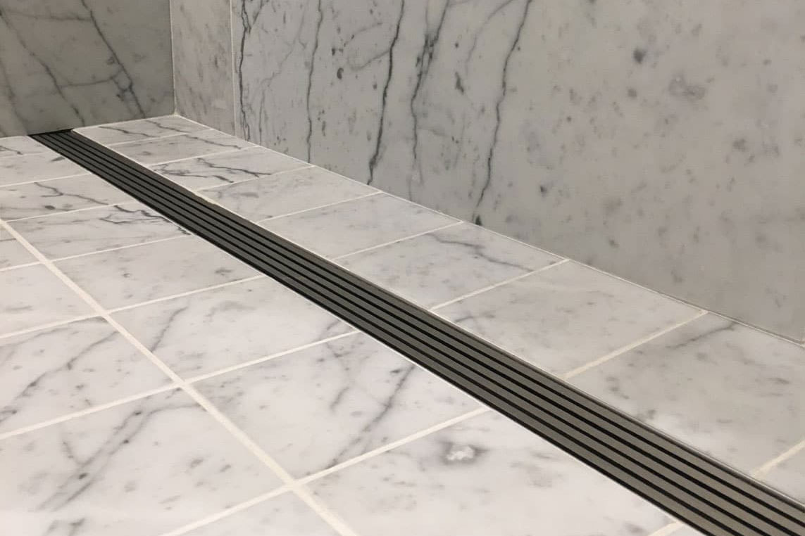 QuickDrain USA Linear Shower Drains Save Time and Ease Installation for Luxury Hotel Bathroom Renovation
